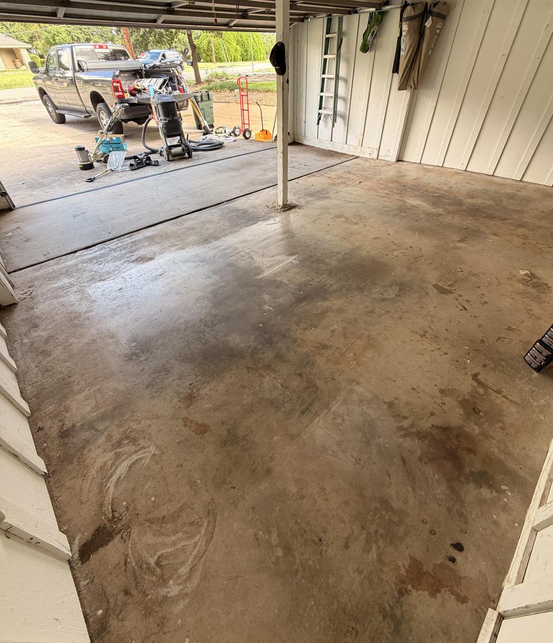 Bare stained concrete garage floor in Granbury before coating